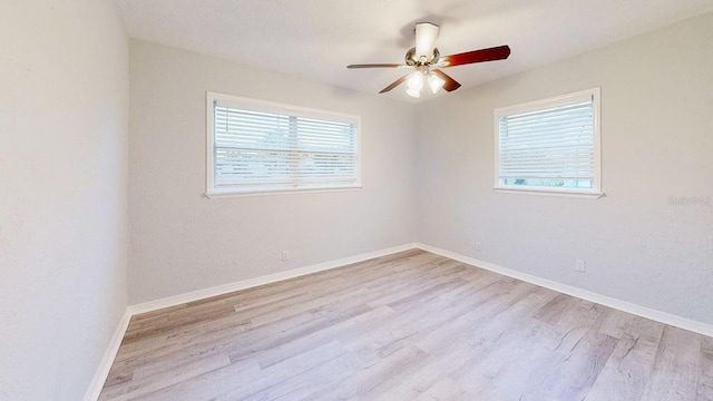 empty room with light wood-type flooring and ceiling fan