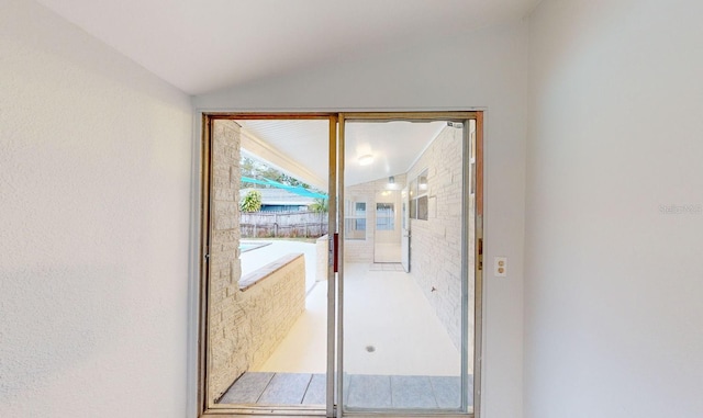 doorway featuring lofted ceiling