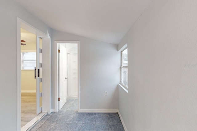 corridor featuring lofted ceiling