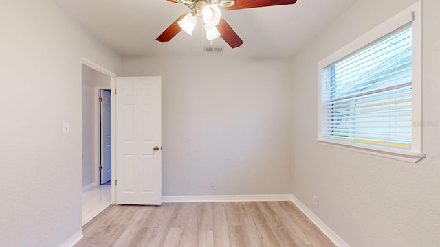 empty room with light wood-type flooring and ceiling fan