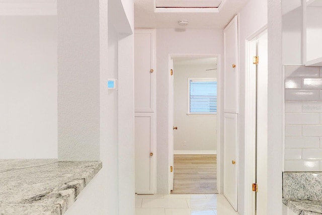 corridor with light tile patterned floors