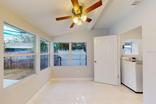 interior space featuring ceiling fan, washer / clothes dryer, lofted ceiling with beams, and a healthy amount of sunlight