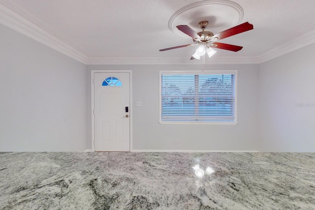 foyer with ornamental molding and ceiling fan