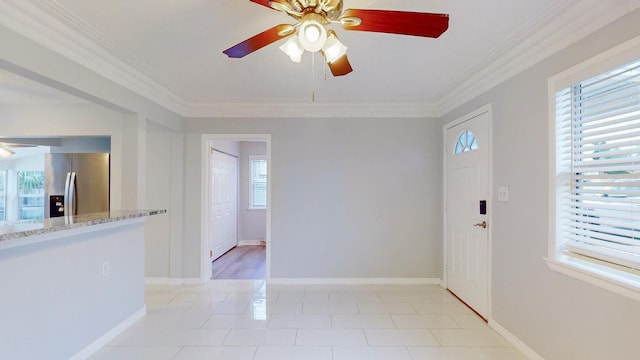 entryway with ornamental molding, ceiling fan, and plenty of natural light