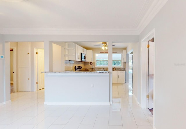 kitchen with light stone counters, white cabinetry, backsplash, and kitchen peninsula