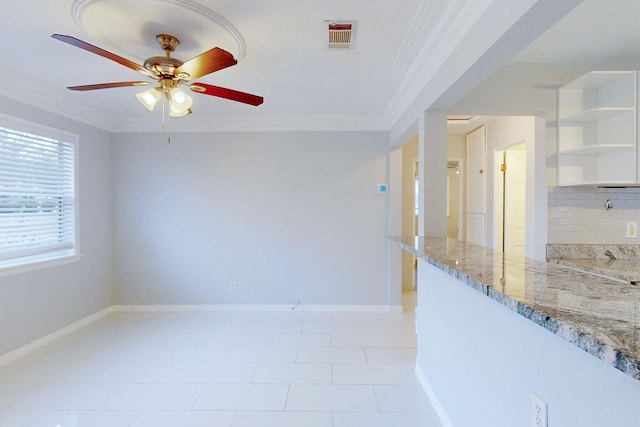 spare room with a wealth of natural light, ceiling fan, and crown molding