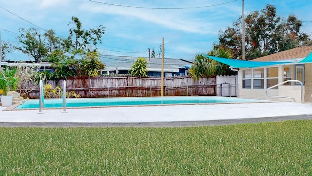 view of pool with a lawn