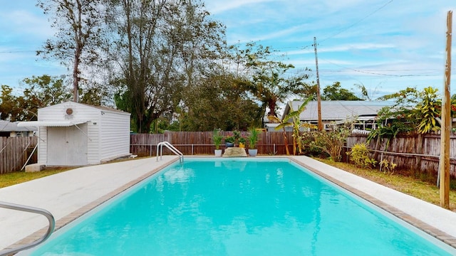 view of pool with a storage shed