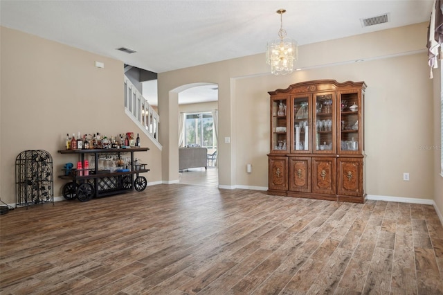 interior space with wood-type flooring and a notable chandelier