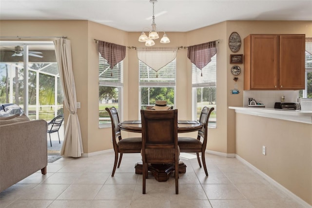 dining area featuring light tile patterned floors and a chandelier