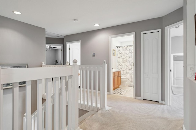 hallway with light colored carpet