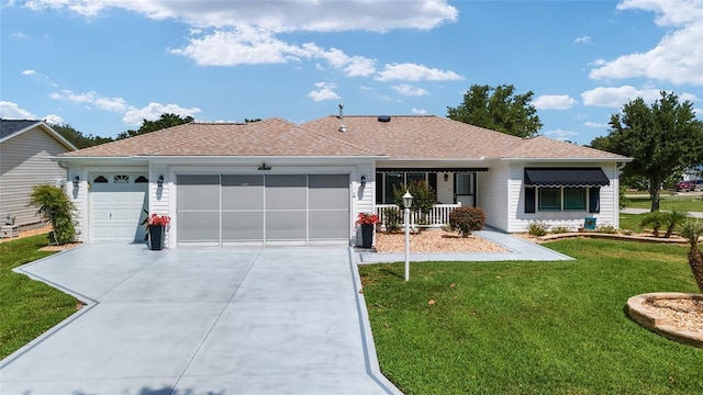 ranch-style home featuring a front yard, a garage, and covered porch