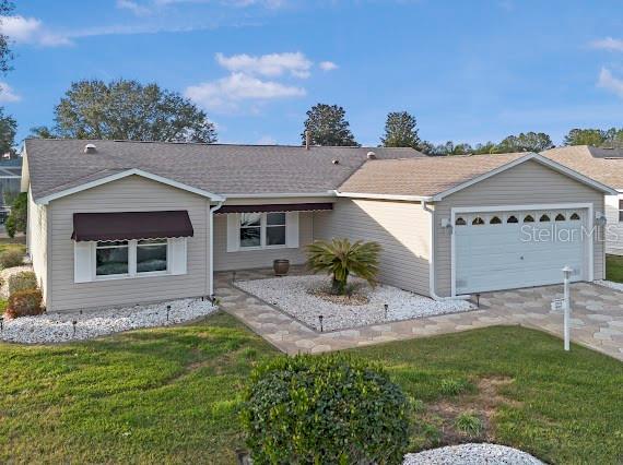 ranch-style home featuring a front yard and a garage