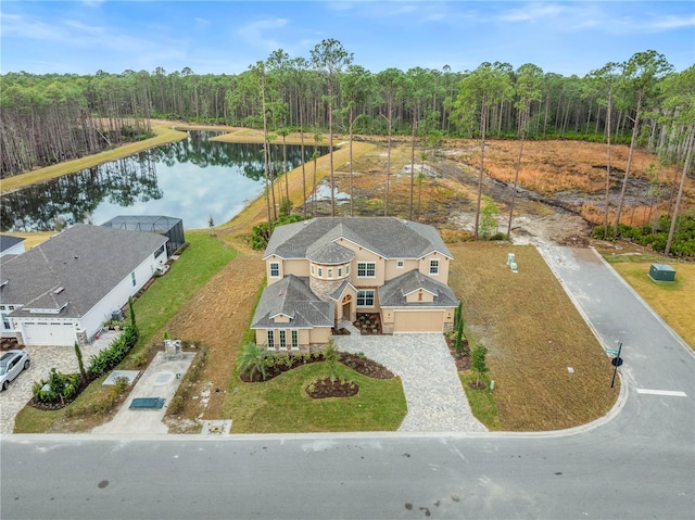 drone / aerial view with a view of trees and a water view