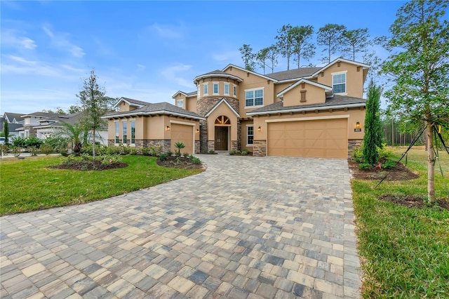 view of front of home featuring stucco siding, stone siding, a front yard, and decorative driveway