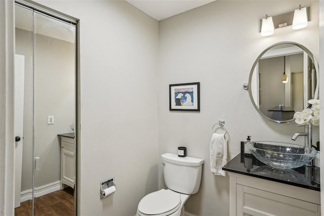 bathroom featuring toilet and vanity