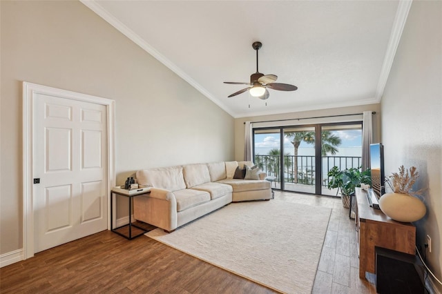 living room with ceiling fan, wood-type flooring, vaulted ceiling, and ornamental molding