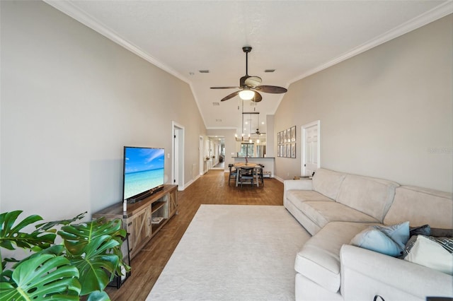 living room with vaulted ceiling, ornamental molding, ceiling fan with notable chandelier, and dark hardwood / wood-style floors