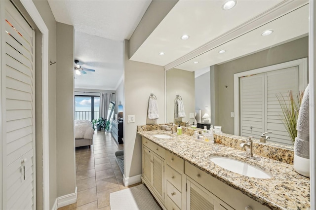 bathroom with ceiling fan, tile patterned floors, vanity, and crown molding