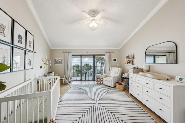 bedroom with ceiling fan, a textured ceiling, lofted ceiling, and ornamental molding