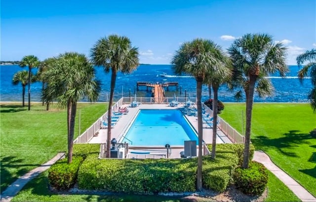 view of pool with a water view, a lawn, and a pergola