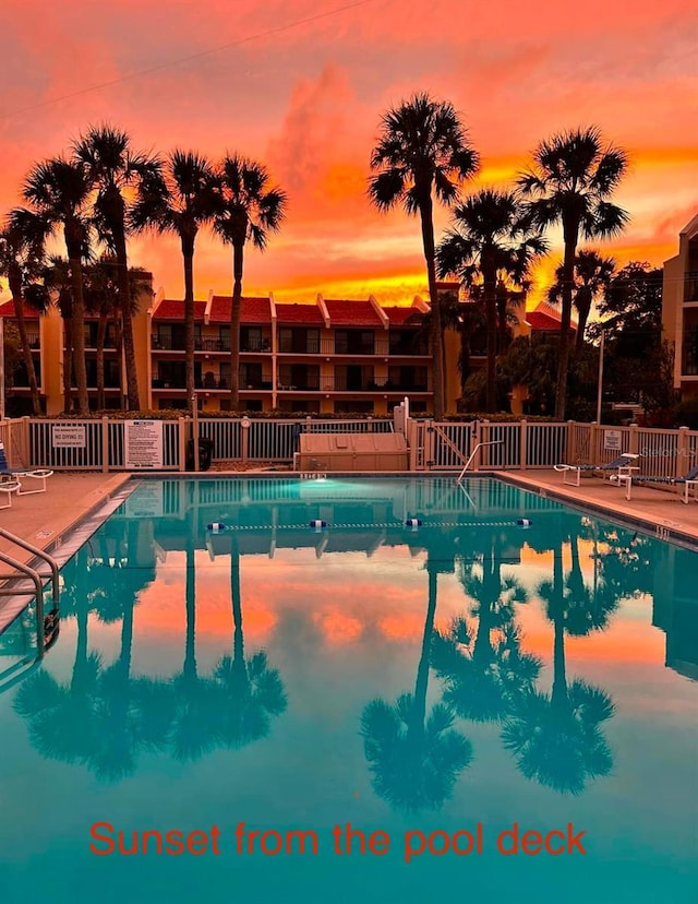 pool at dusk featuring a patio area