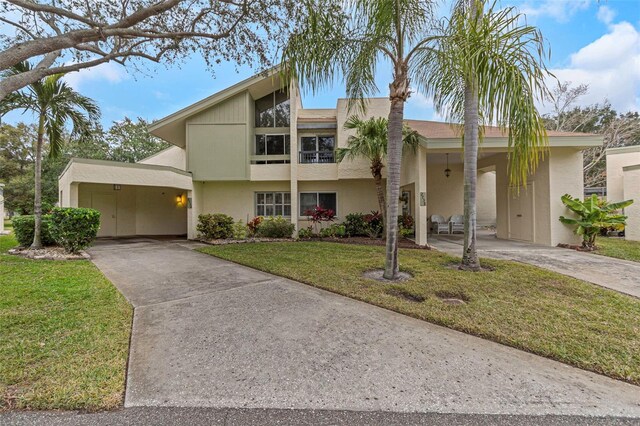 view of front facade with a front lawn and a carport