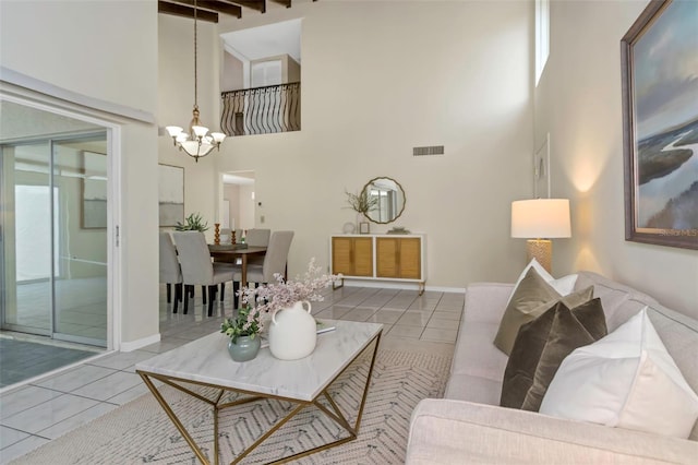 living room with light tile patterned floors, beamed ceiling, a high ceiling, and a chandelier