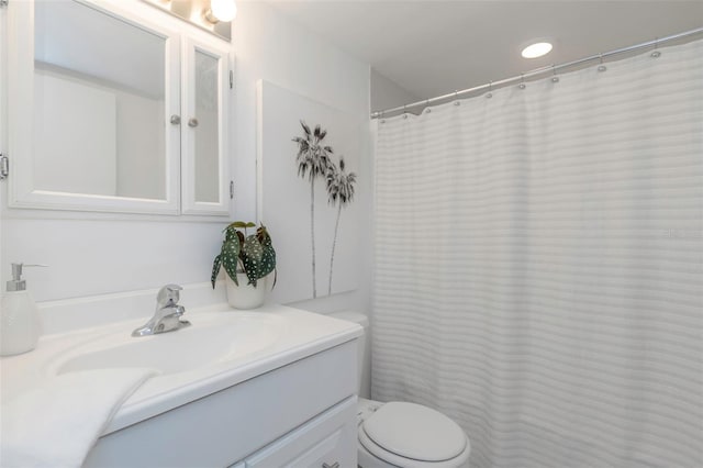 bathroom featuring toilet and vanity