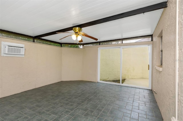 unfurnished sunroom featuring ceiling fan and a wall mounted AC