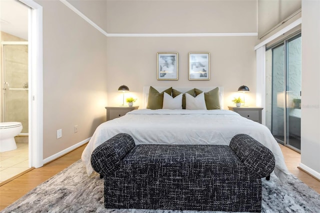 bedroom featuring ensuite bath and light hardwood / wood-style flooring