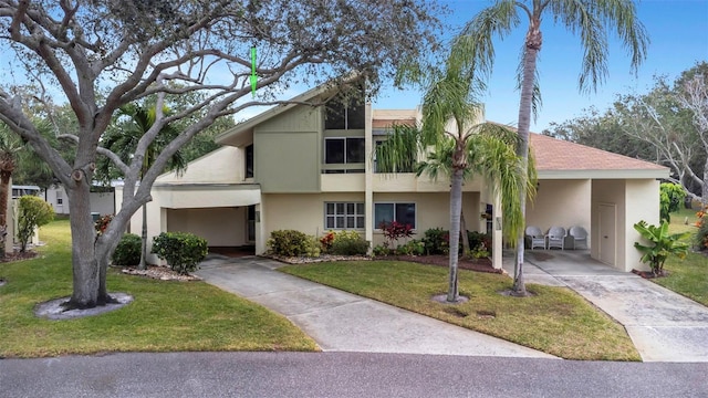 view of front of house with a front yard and a carport