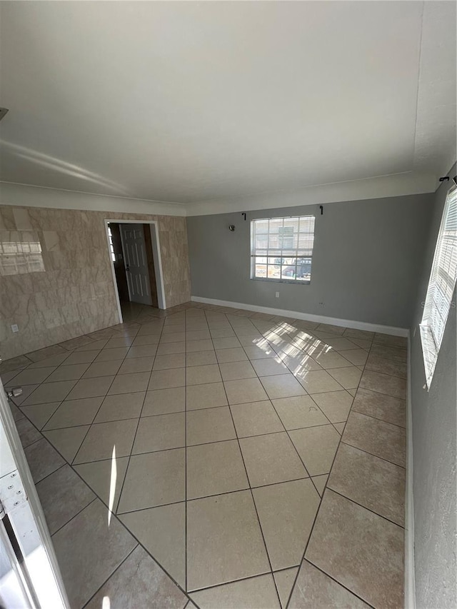 unfurnished room featuring light tile patterned flooring