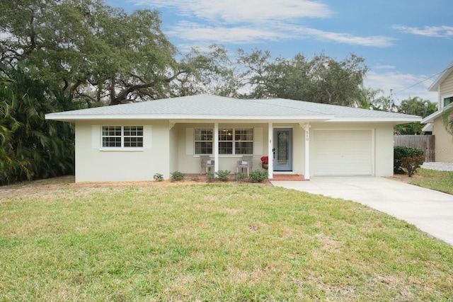 ranch-style house featuring a garage and a front lawn