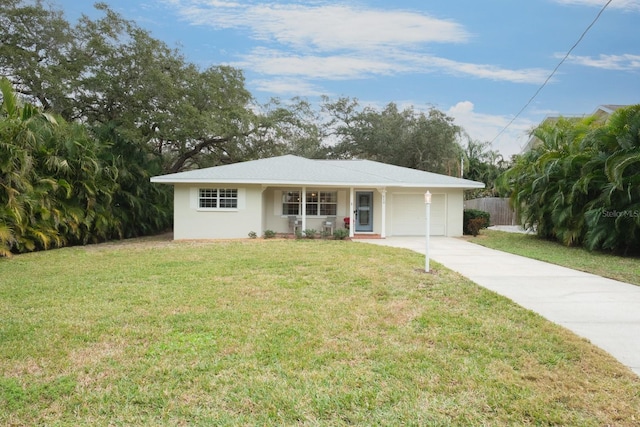 ranch-style home featuring a garage and a front lawn