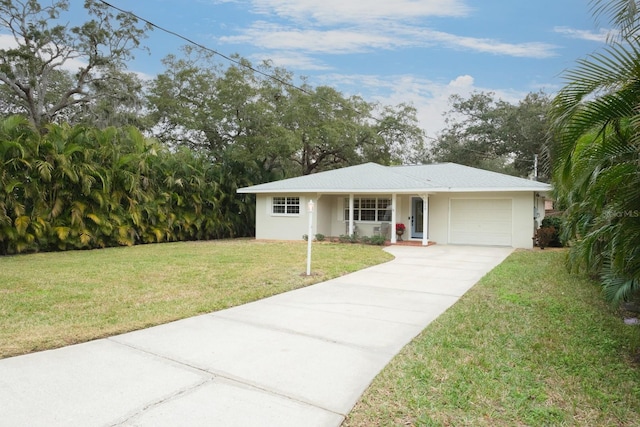 ranch-style house featuring a garage and a front yard