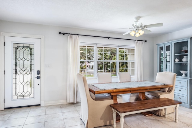 tiled dining room with ceiling fan