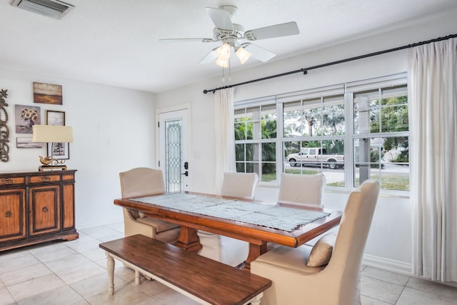 dining area with a healthy amount of sunlight, ceiling fan, and light tile patterned floors