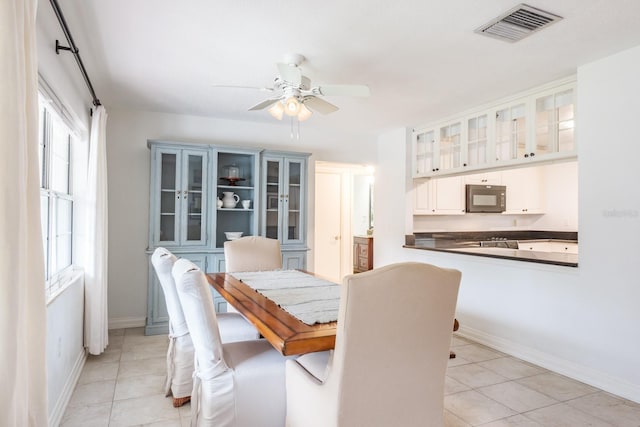 tiled dining room featuring ceiling fan