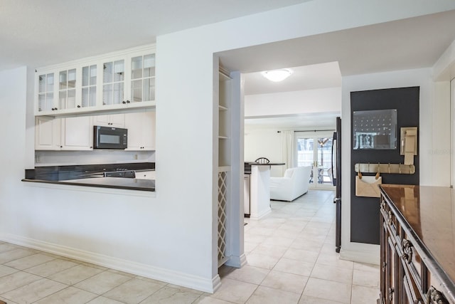 kitchen featuring white cabinets and light tile patterned floors