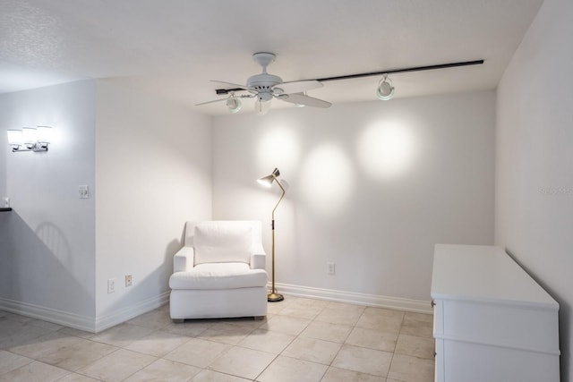 sitting room featuring ceiling fan and light tile patterned floors