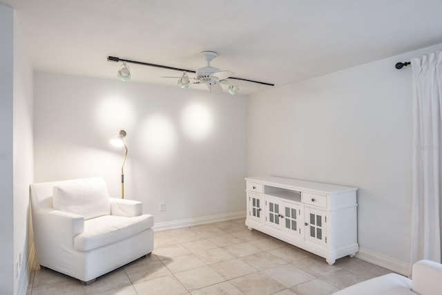 sitting room featuring ceiling fan and light tile patterned floors