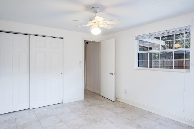 unfurnished bedroom with ceiling fan and a closet