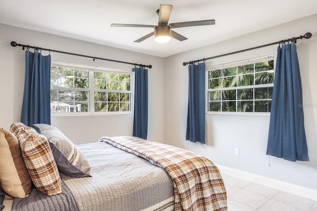 tiled bedroom featuring ceiling fan