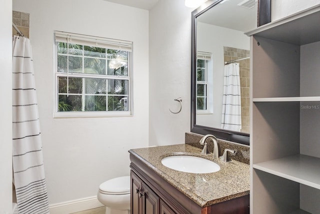 bathroom with toilet and vanity