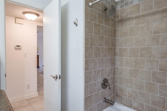 bathroom with tile patterned flooring and tiled shower / bath