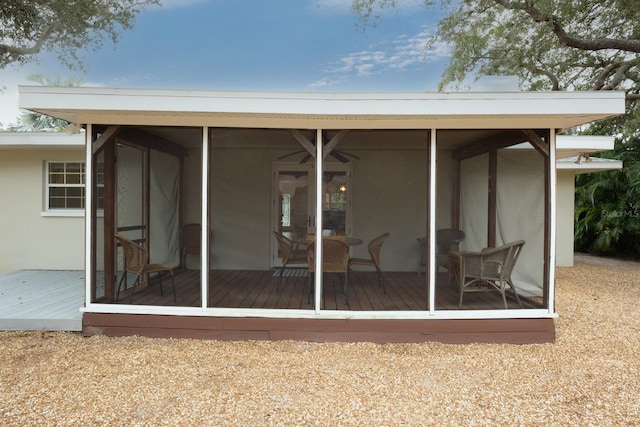 back of house with a deck and a sunroom