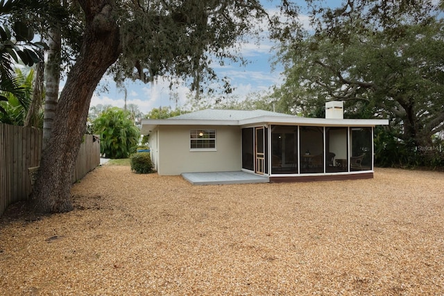 back of property featuring a sunroom and a patio