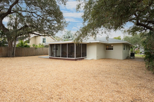 rear view of property featuring central AC and a sunroom