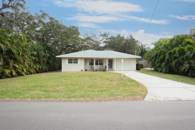 ranch-style house featuring a garage and a front lawn